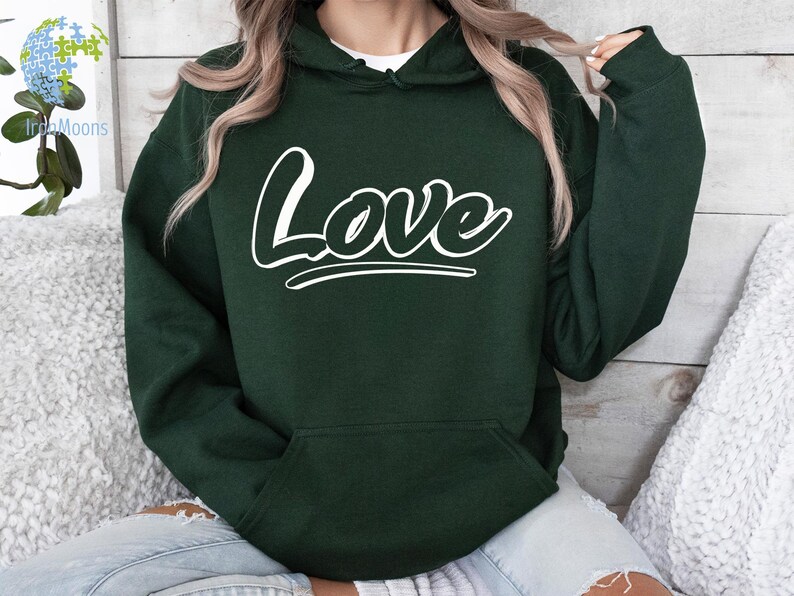 May include: A dark green hooded sweatshirt with a white "Love" graphic on the front.