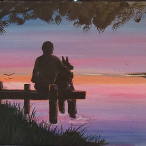 May include: Silhouette of a person and a dog sitting on a wooden dock overlooking a lake at sunset. The sky is a vibrant mix of pink, purple, and orange.