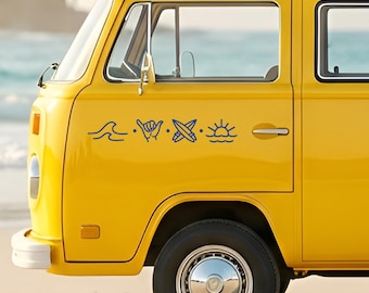 May include: A bright yellow vintage van with a dark blue wave, hand, surfboard, and sun decal on the side. The van has a chrome hubcap and is parked on a sandy beach.