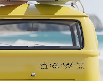 May include: A bright yellow van features a black decal on its rear window area. The decal displays a series of four icons: a rising sun, a spiral seashell, a small crab, and a whale tail, all separated by small four-pointed star symbols.