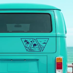 May include: A teal-colored van with a dark blue triangular decal featuring a beach scene. The decal includes palm trees, a sun, mountains, and birds. The van's taillight is visible.