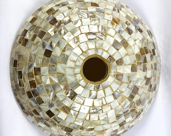 May include: A round, white and brown mosaic sink made of mother of pearl tiles.