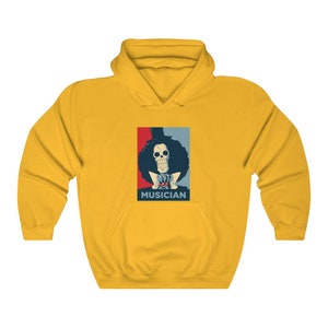 May include: Yellow hoodie with a graphic of a skeleton character with a top hat and the word "MUSICIAN" printed below.