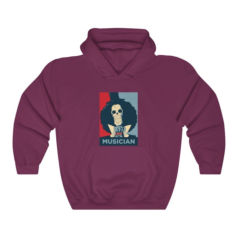 May include: A maroon hoodie with a graphic of a cartoon skeleton with a top hat and a red, white, and blue background. The text "MUSICIAN" is below the graphic.
