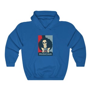 May include: A blue hoodie with a graphic of a skeleton character with a top hat and afro, wearing a red bow tie. The graphic is in a red, white, and blue color scheme and has the word "MUSICIAN" printed below it.