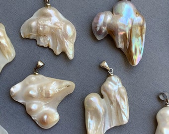 May include: A collection of six irregular shaped baroque pearl pendants with silver bail settings. The pearls are white with iridescent hues.