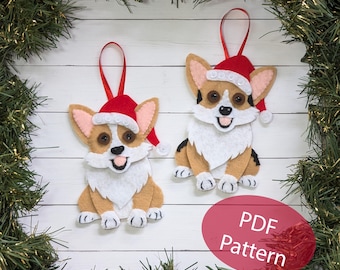 May include: Two felt Christmas ornaments of corgis wearing Santa hats. The ornaments are brown, white, and black. The text "PDF Pattern" is on a red circle in the bottom right corner of the image.