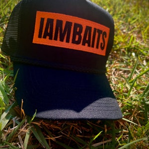 IAMBAITS: orange black trucker hat