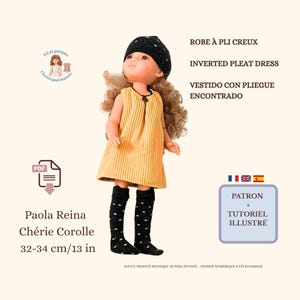 May include: A doll wearing a yellow corduroy inverted pleat dress, black beanie, and black knee-high socks with white polka dots. The doll is 13 inches tall. Text on the image includes "INVERTED PLEAT DRESS" and "PATRON + TUTORIEL ILLUSTRÉ."