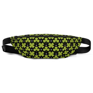 May include: A fanny pack featuring a repeating pattern of light green three-leaf clovers and four-leaf clovers on a black background, interspersed with small white four-pointed stars. The bag includes a black zipper and an adjustable black strap.