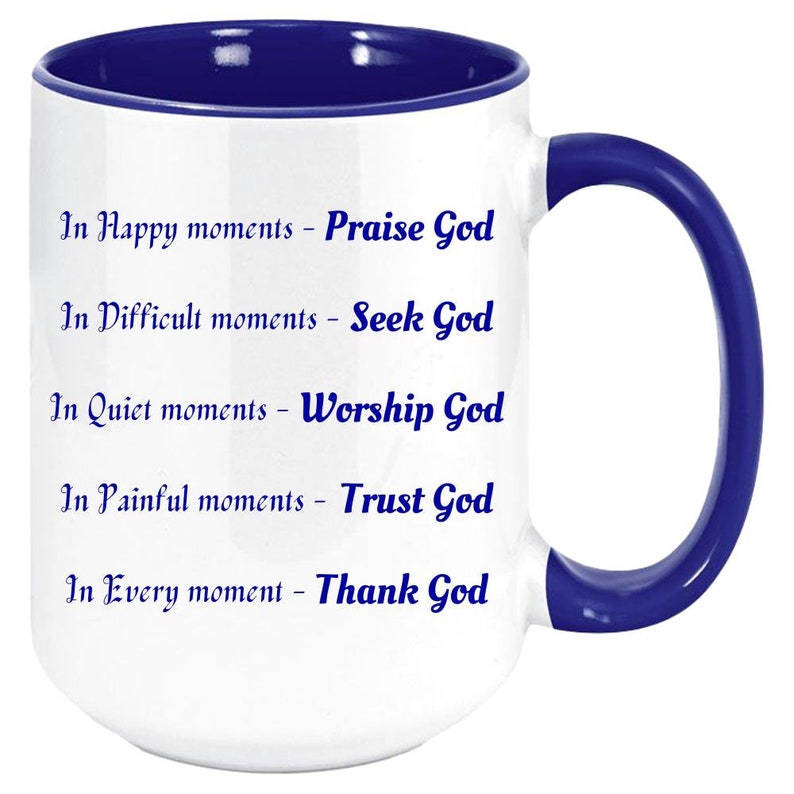 May include: White ceramic mug with a blue interior and handle. The mug features the text "In Happy moments - Praise God, In Difficult moments - Seek God, In Quiet moments - Worship God, In Painful moments - Trust God, In Every moment - Thank God."