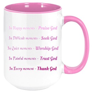 May include: White ceramic mug with a pink interior, handle, and rim. The mug features the text "In Happy moments - Praise God, In Difficult moments - Seek God, In Quiet moments - Worship God, In Painful moments - Trust God, In Every moment - Thank God."
