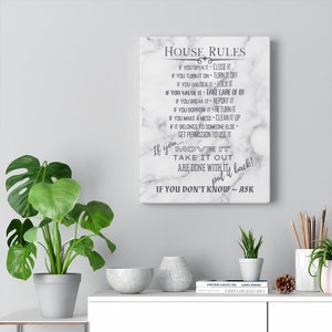 May include: A white canvas print with a marble background and black text that reads "House Rules". The text lists rules for using items in a home, such as "If you open it, close it" and "If you move it, take it out, put it back!"