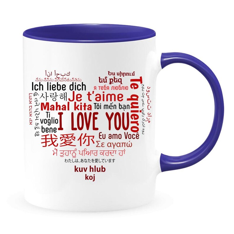 May include: White ceramic coffee mug with a blue rim and handle. The mug features a red word cloud with the words "I love you" in multiple languages.