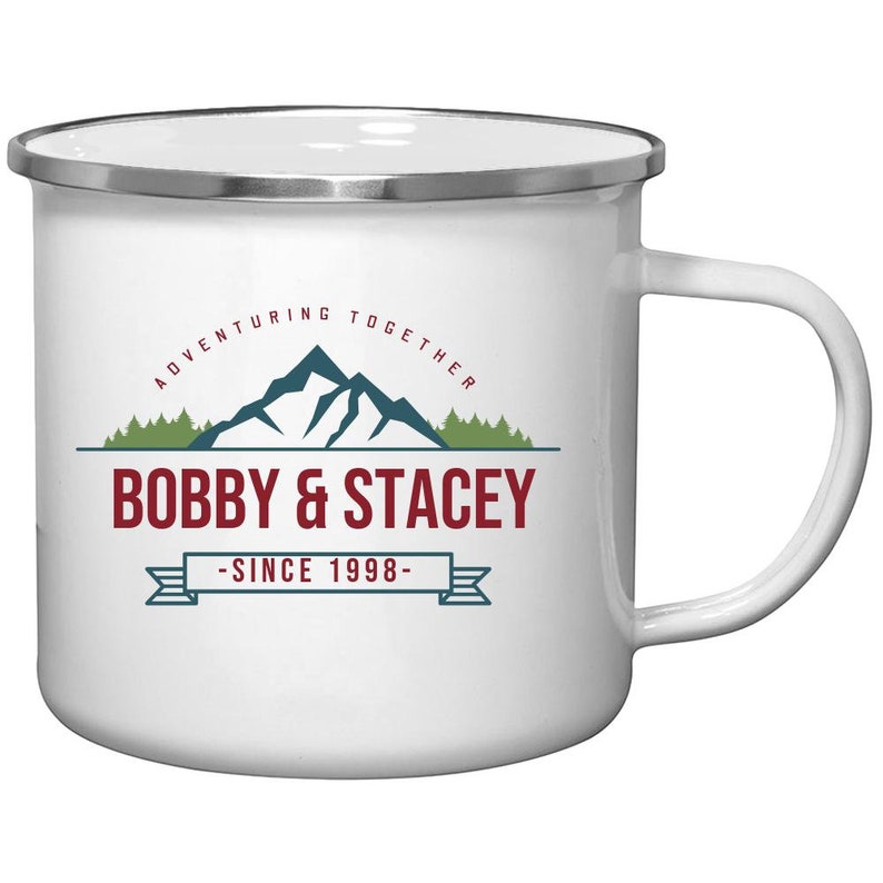 May include: White enamel camping mug with a silver rim. It features a mountain range graphic with the text "Adventuring Together Bobby & Stacey - Since 1998 - "