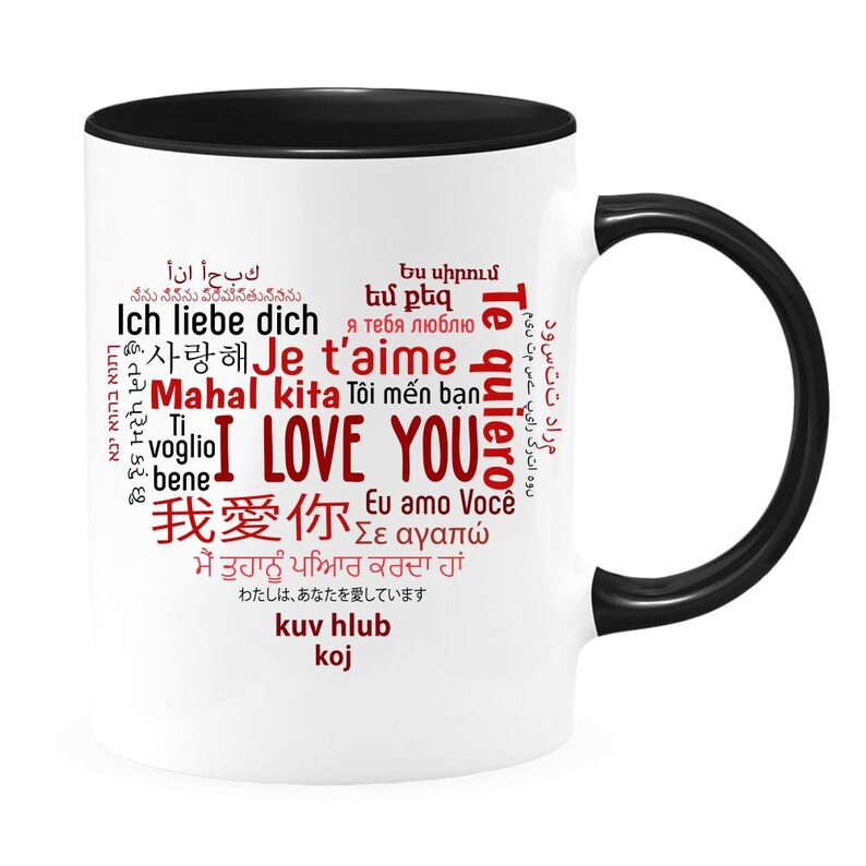 May include: White ceramic mug with a black rim and handle. The mug features a red heart-shaped word cloud with the words "I Love You" in English and various other languages, including "Te quiero", "Je t'aime", "Ich liebe dich", and "Mahal kita".