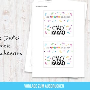 May include: Two white printed sheets with the text "CIAO KAKAO" in black, green, and yellow, surrounded by colorful confetti. The text "Danke f&uuml;r die kunterbunte Zeit" is also present. The sheets are on a wooden surface.