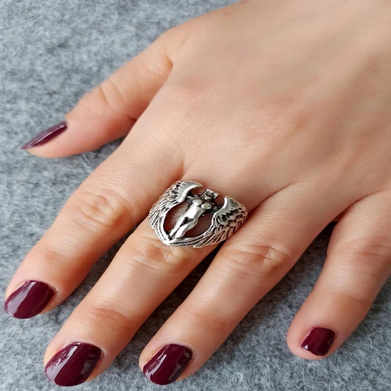 Adjustable female figure angel ring with spread wings, inspired by fantasy themes.
