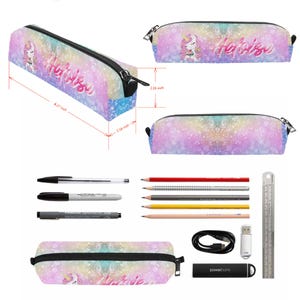 May include: A pencil case with a pastel rainbow bokeh background, a unicorn illustration, and the name Heloise in script. It measures 8.27 inches long, 2.16 inches high, and 2.16 inches wide. Includes pens, pencils, a cable, and a power bank.