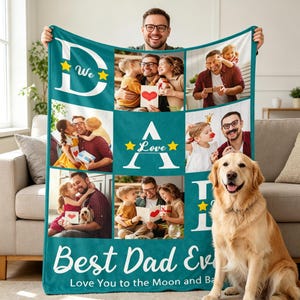 May include: A teal blanket with family photos and the text "Best Dad Ever." The blanket features the words "We Love" with star accents. A golden retriever sits in front of the blanket.