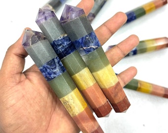 May include: Set of seven chakra wands, each with a different colored stone representing a chakra. The wands are made of amethyst, clear quartz, sodalite, green aventurine, citrine, carnelian, and red jasper.