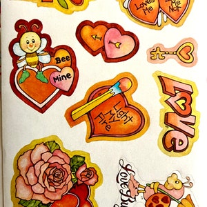 May include: A sheet of Valentine's Day stickers featuring various designs, including hearts, flowers, bees, and a love bug. The stickers are colorful and feature a variety of romantic themes.
