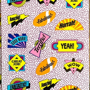 May include: A white background with a repeating pattern of small red and blue dashes.  The background is covered with colorful stickers with motivational phrases like "Fantastic!" "Wow!" "Great Job!" "Amazing!" "Fabulous!" "Hurrah!" "Good Work!" "Terrific!" "Yeah!"  The stickers are in various shapes and colors, including yellow, orange, pink, blue, and red.