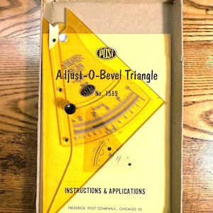 May include: A vintage yellow Adjust-O-Bevel Triangle by POST, model No. 1589, inside its original cardboard box. The triangle features degree and bevel markings. The box also contains instructions and applications from Frederick Post Company, Chicago 90.