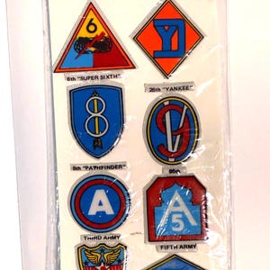 May include: A sheet of vintage "Famous Military Insignia" puffy stickers. The stickers feature various military unit emblems in red, blue, yellow, and orange. The package includes the "Airborne" logo and the text "AGES 3 & UP."