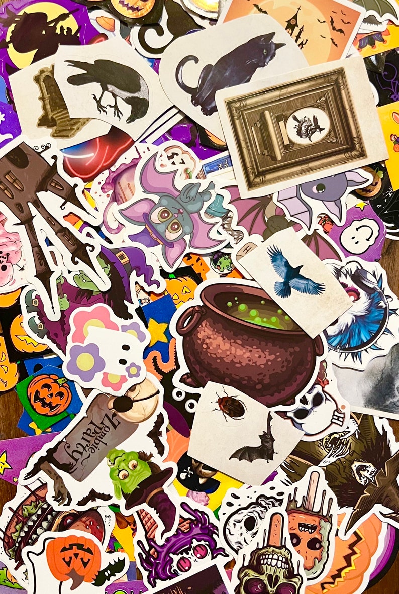 May include: A collection of Halloween themed stickers featuring various spooky characters, including bats, witches, ghosts, pumpkins, and a cauldron. The stickers are printed on white paper and have a glossy finish.