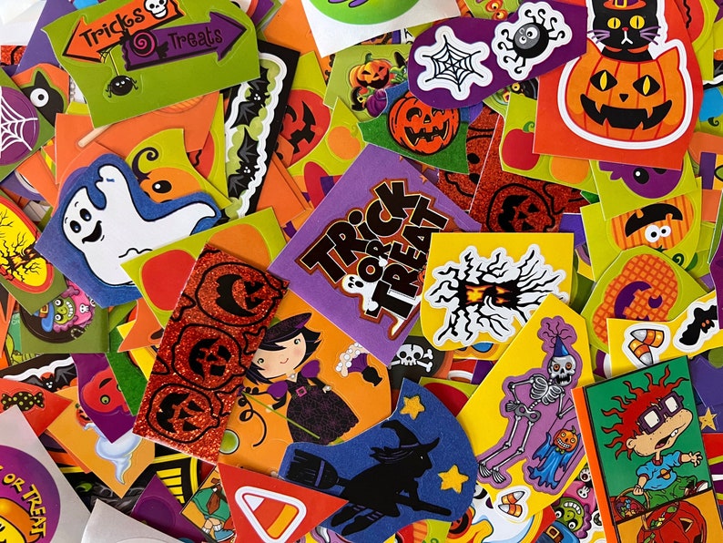 May include: A collection of colorful Halloween stickers featuring various spooky and fun designs, including ghosts, pumpkins, bats, witches, and skeletons. The stickers have phrases like "Trick or Treat" and "Happy Halloween".