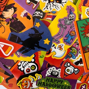 May include: A colorful assortment of Halloween-themed scrapbook paper featuring various characters, including a witch, a skeleton, and a cartoon character. The paper is decorated with pumpkins, candy corn, and other Halloween symbols. The text "Happy Halloween" is visible on one of the papers.