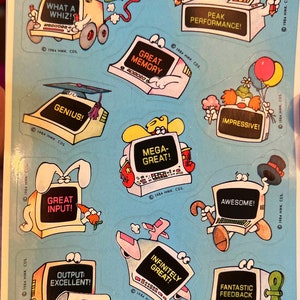 May include: A set of ten colorful computer-themed stickers with various phrases like "What a Whiz!" and "Peak Performance!"  Each sticker features a cartoon computer with a different expression and personality.