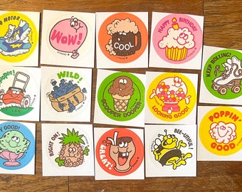 May include: A set of 12 colorful round stickers with various cartoon characters and phrases. The stickers feature themes like birthday, ice cream, and transportation. The stickers are printed with the word "Trend" on each one.