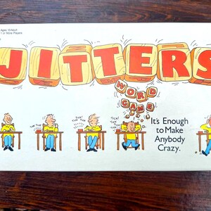 May include: A vintage board game box titled "JITTERS" with large orange letters. The box features cartoon illustrations of people at desks, with the text "WORD GAME" and "It's Enough to Make Anybody Crazy."