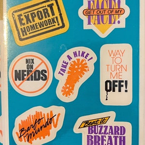 May include: A sheet of vintage stickers with various phrases in bold text. Designs include "EXPORT HOMEWORK!", "FACE! GET OUT OF MY FACE!", "NIX ON NERDS", "TAKE A HIKE!", "WAY TO TURN ME OFF!", "Barfo Mundo", and "Beat it BUZZARD BREATH".