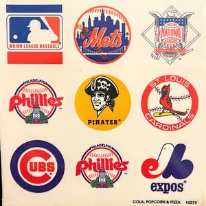 May include: Sheet of baseball team logo stickers, including the MLB logo, Mets, Phillies, Pirates, Cubs, Cardinals, Expos, and National League logos. The stickers are colorful and round, with team names and logos.