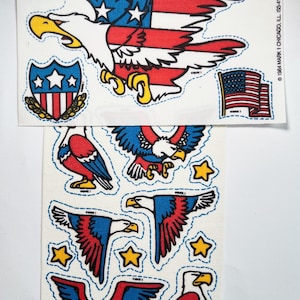 May include: A sheet of stickers featuring an American bald eagle with a red, white, and blue American flag design. The sheet also includes smaller stickers of eagles and stars.