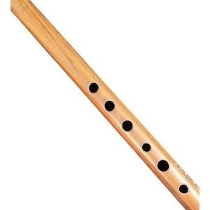 May include: A light brown wooden flute featuring a smooth, polished grain finish and a series of six circular finger holes aligned along the length of the instrument. The cylindrical body shows natural wood textures and a consistent, warm tone.