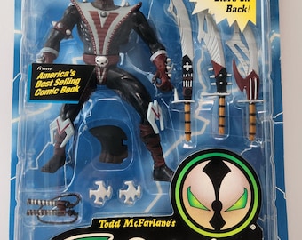 May include: Ninja Spawn action figure in a sealed package. The figure is black, red, and white, with multiple weapons. The packaging includes text that reads "America's Best Selling Comic Book" and "Ultra-Action Figures."