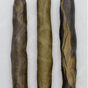 May include: Three wooden sticks with different brown and tan color variations. The text "Color May Vary" is written above the sticks.