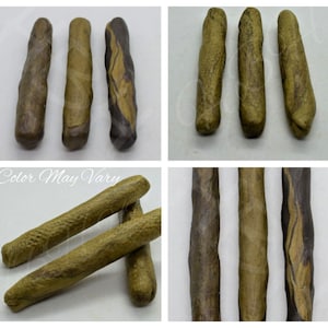 May include: Three brown and black striped sticks with a rough texture.  Color May Vary.