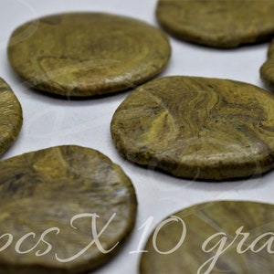 May include: Three round, green and brown, marbled, pressed discs, each weighing 10 grams. 3 pcs X 10 grams.