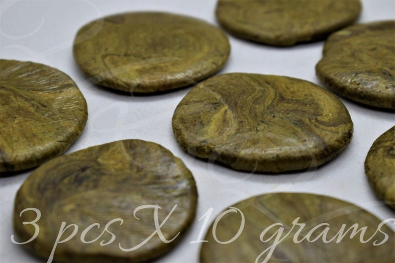 May include: Three round, green and brown, marbled, pressed discs, each weighing 10 grams. 3 pcs X 10 grams.