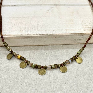 Brown, bronze, copper and glass bead necklace, with 5 antique bronze discs interspersed. Choice of length. Comes with a 3cm chain extender. Beautiful rustic or tribal jewellery.