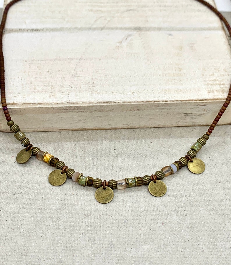 Brown, bronze, copper and glass bead necklace, with 5 antique bronze discs interspersed. Choice of length. Comes with a 3cm chain extender. Beautiful rustic or tribal jewellery.