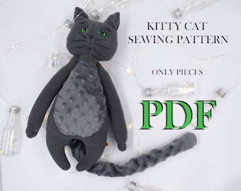 May include: Gray plush kitty cat sewing pattern PDF. The pattern includes all the pieces needed to sew a gray cat with green eyes.