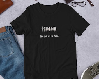 May include: A black short-sleeved t-shirt featuring a graphic of a row of white ghost-like figures. Below the figures, the text reads "You give me the Wilis" in a white, stylized font. The shirt has a crew neckline and a standard fit.