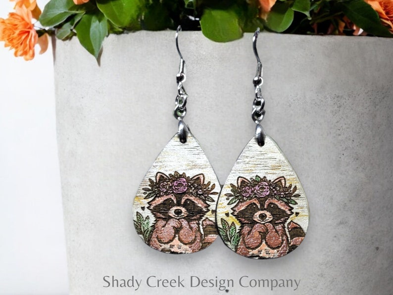 Hand Painted Wood Earrings of a Raccoon Wearing a Floral Crown, Handcrafted Wood Dangle Earrings, Raccoon Drop Earrings, Animal Earrings image 1