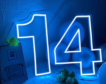 May include: Neon light sign shaped like the number 14. The sign is white and glows blue. The sign is surrounded by blue balloons.